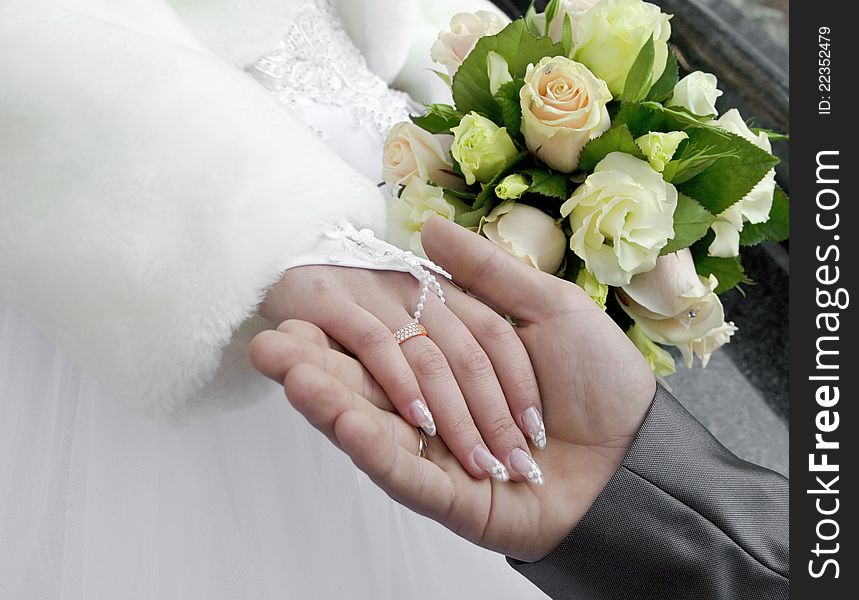 Groom Holds The Hand Of Fiancee