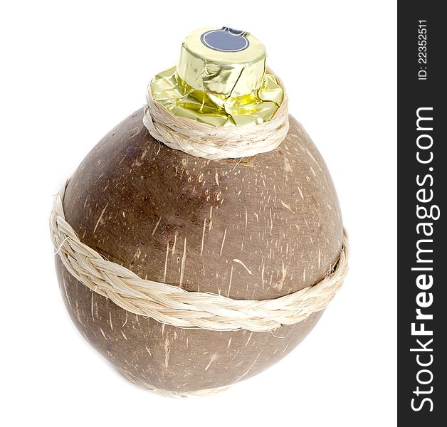 A coconut container containing coconut liqueur isolated on white.