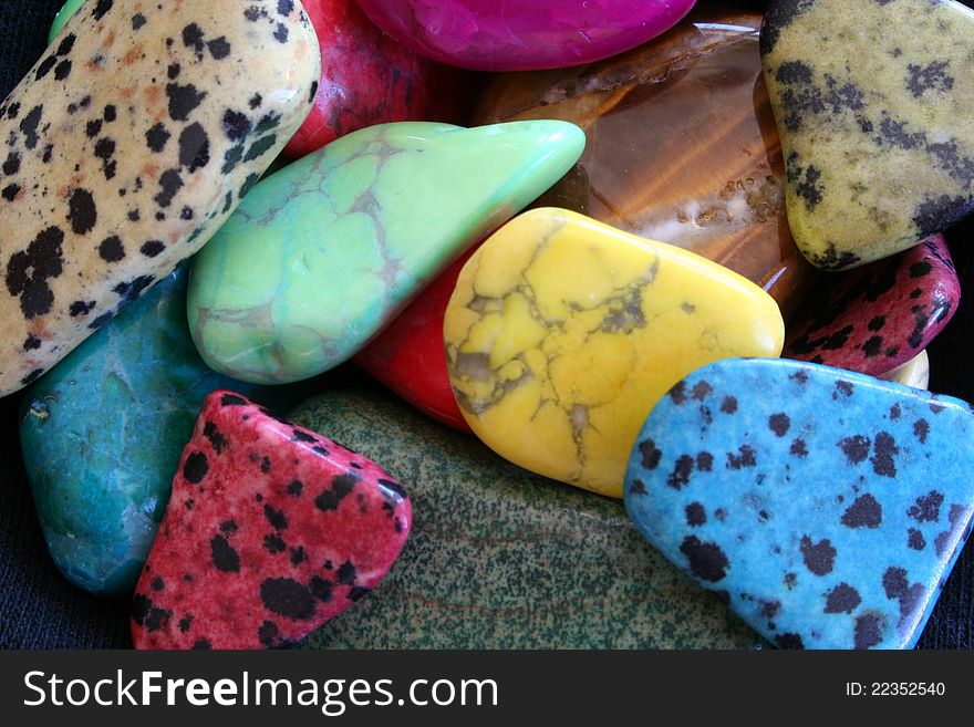 Polished colored stones rocks background. Polished colored stones rocks background