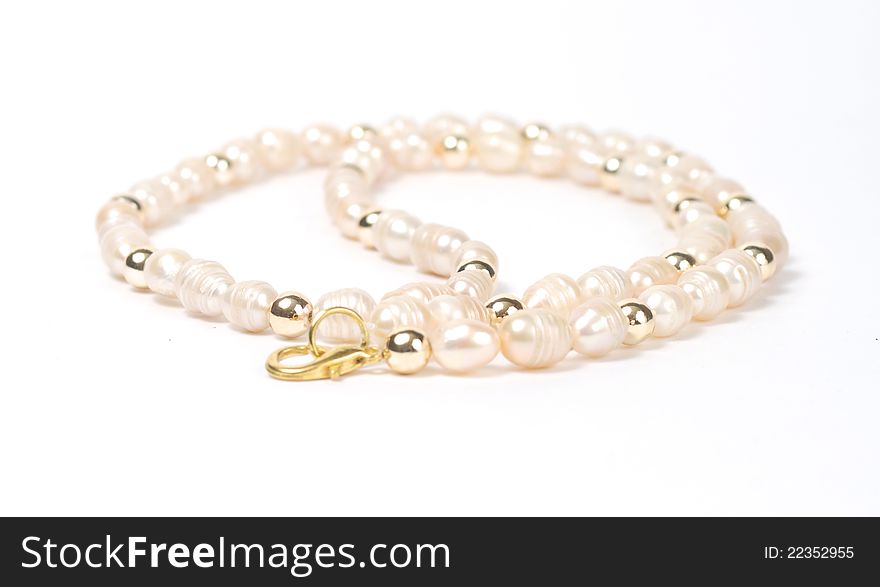 Necklace of pink pearls on white background
