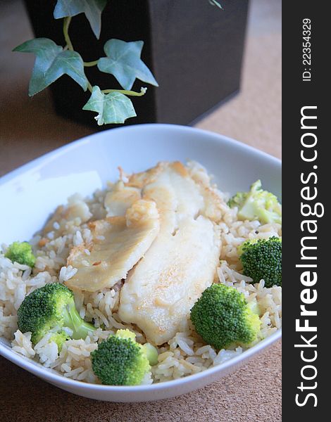 A bowl of fried rice with seafood and broccoli on table for lunch or dinner. A bowl of fried rice with seafood and broccoli on table for lunch or dinner