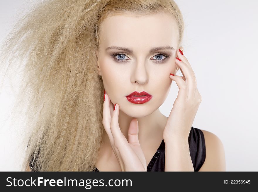 Young pretty woman with beautiful blond hairs and multicolor makeup isolated on white background