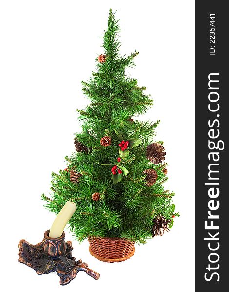 Christmas tree and candle in a metal candlestick on white background