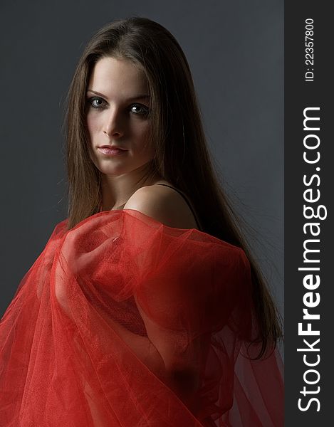 Portrait of sensual young woman wrapped in a red nylon with beautiful long hair. Portrait of sensual young woman wrapped in a red nylon with beautiful long hair