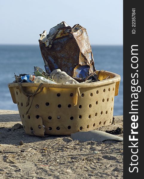 Garbage collected in a plastic basket. Garbage collected in a plastic basket