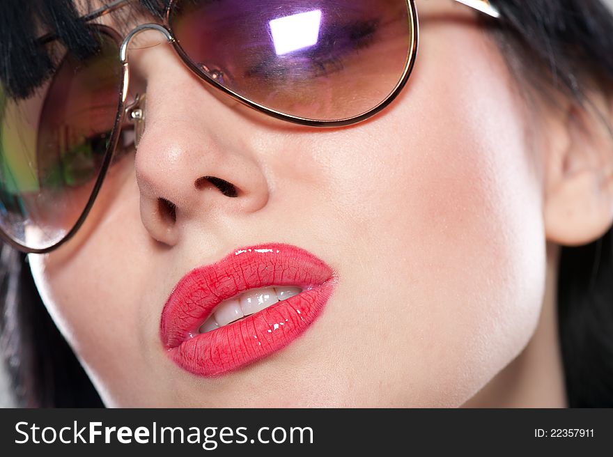 Close-up portrait of sensual and tender woman's face wearing sunglasses. Close-up portrait of sensual and tender woman's face wearing sunglasses