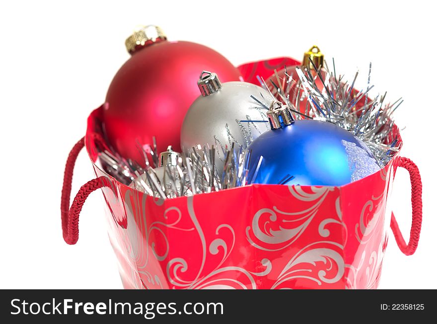 Christmas balls in gift bag isolated on white