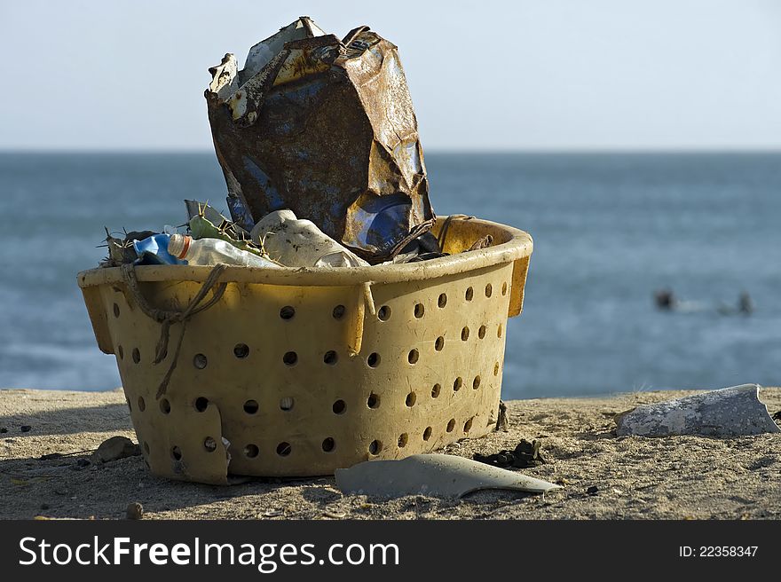 Garbage collected in a plastic basket. Garbage collected in a plastic basket