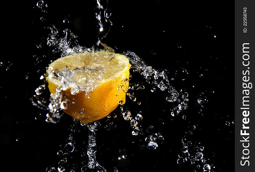 Fresh water splash and lemon isolated on black. Fresh water splash and lemon isolated on black.