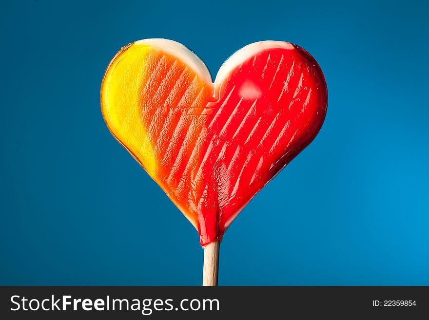 Candy heart on blue background