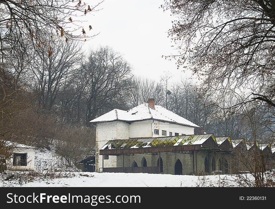 Winter scene of an abandoned rest house, at the fringe of a forest.