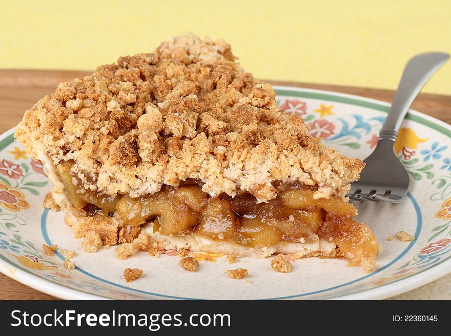 Slice of apple fruit crumb pie on a plate. Slice of apple fruit crumb pie on a plate