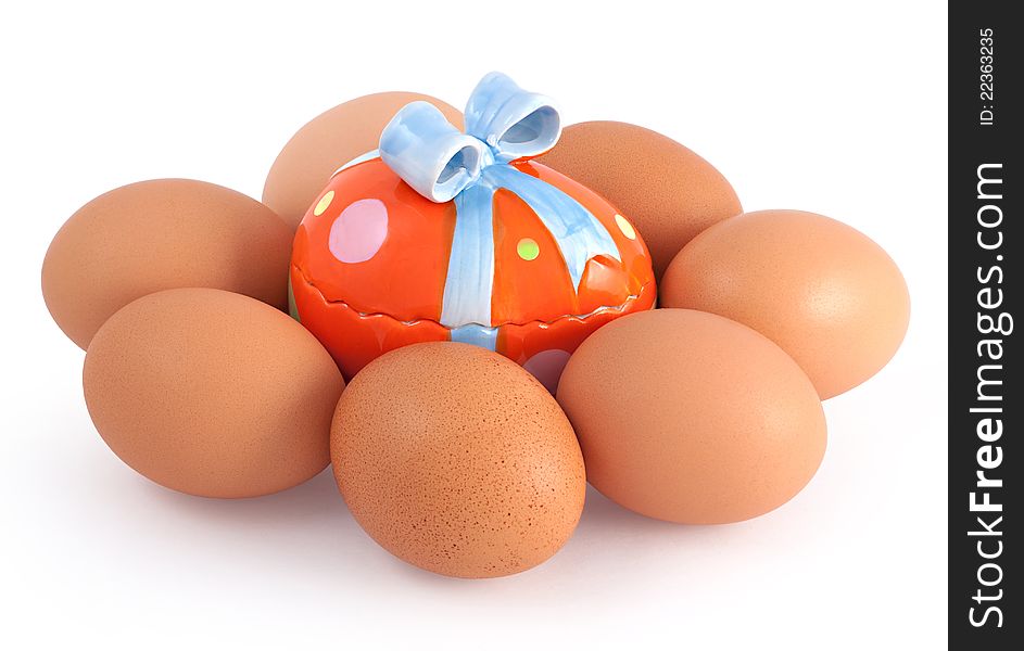 Colored toy egg surrounded by hen's eggs. Colored toy egg surrounded by hen's eggs