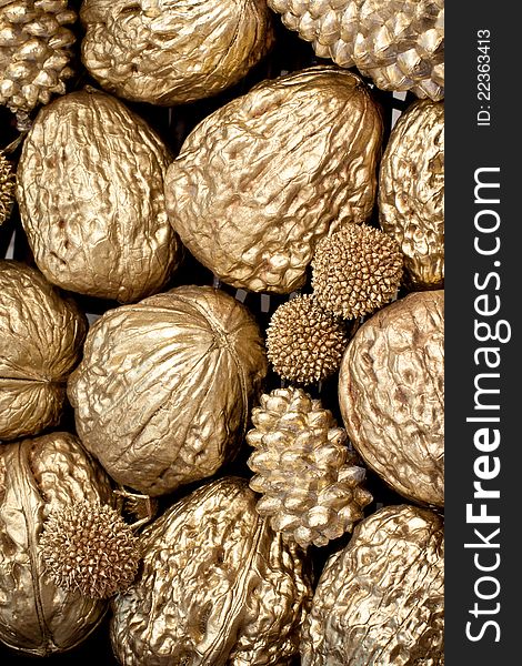 Golden walnuts and pine cones texture. Golden walnuts and pine cones texture