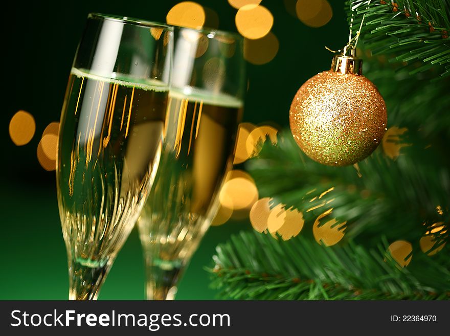 Festive champagne glasses with bokeh lights