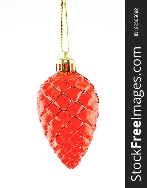 Red cone, Christmas decorations hanging on a golden thread against the white  background. Red cone, Christmas decorations hanging on a golden thread against the white  background
