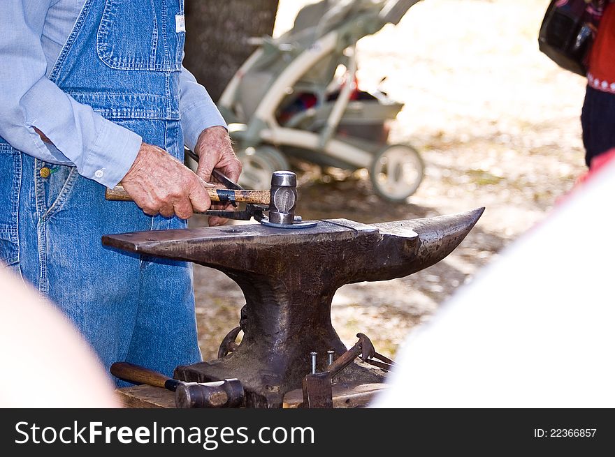 A blacksmith making a horseshoe.