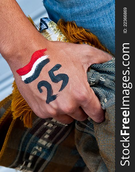 An young person keep on his hand a carpet for islamic pray, on his hand also there is the date of the egyptian revolution . the revolution start from the young people . An young person keep on his hand a carpet for islamic pray, on his hand also there is the date of the egyptian revolution . the revolution start from the young people .