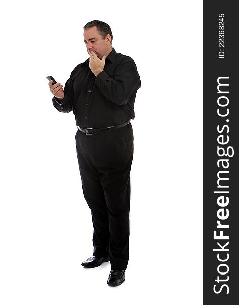 Tall man in black looking at his cellular phone. Tall man in black looking at his cellular phone