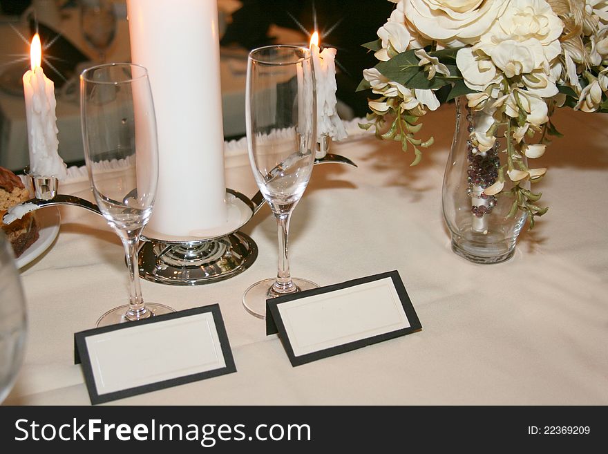 Blank fill-in placecards for couple with linens, champagne glasses, candles and bouquet. Blank fill-in placecards for couple with linens, champagne glasses, candles and bouquet