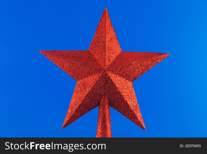 Red five-pointed star toy Christmas tree against a white background. Red five-pointed star toy Christmas tree against a white background