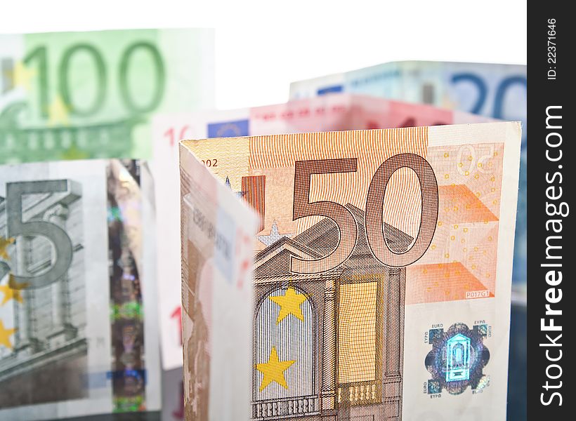 Different euro banknotes over white background
