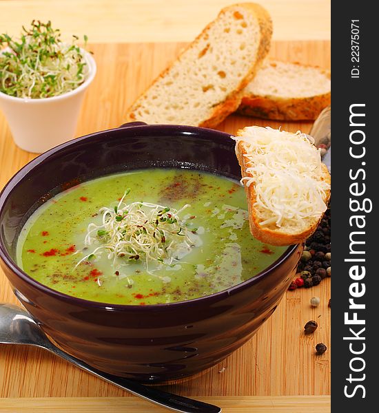 Bowl of peas soup garnished with shaved Parmesan cheese. Bowl of peas soup garnished with shaved Parmesan cheese