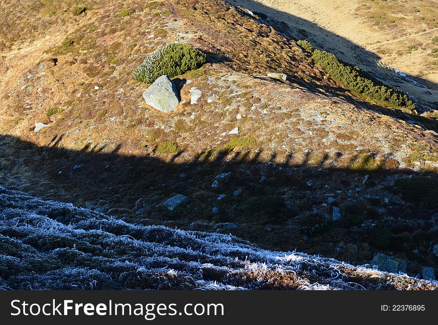 Tourists shadows over mountain ridge