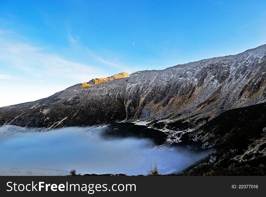 Panoramic shot of a mountain with clouds acting as the bottom. Panoramic shot of a mountain with clouds acting as the bottom