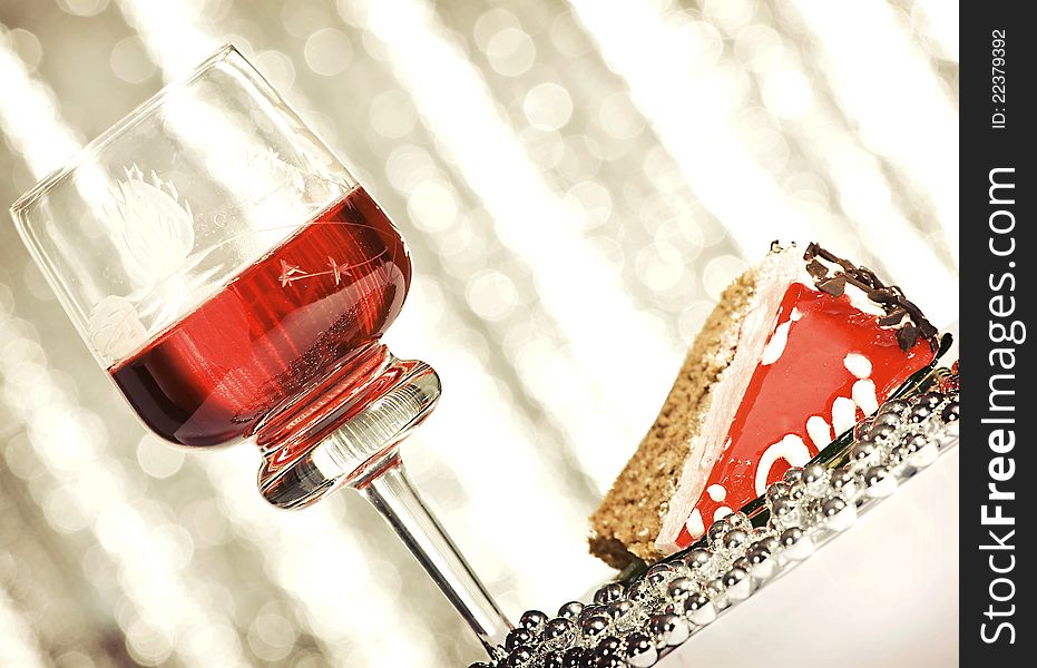 Red wine and cherry cake over abstract background. Red wine and cherry cake over abstract background