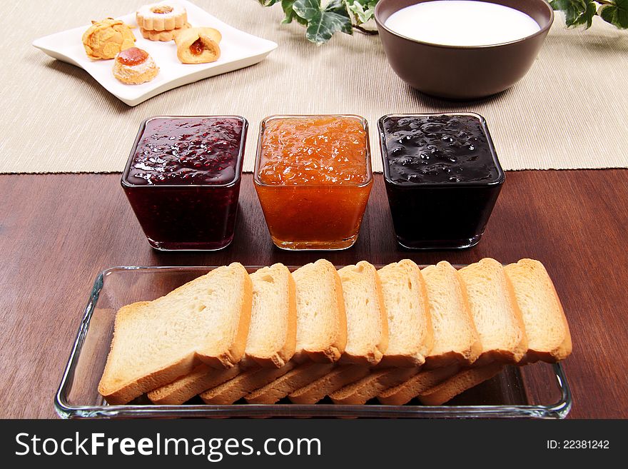 Toasted whit marmalade on the brown table. Toasted whit marmalade on the brown table