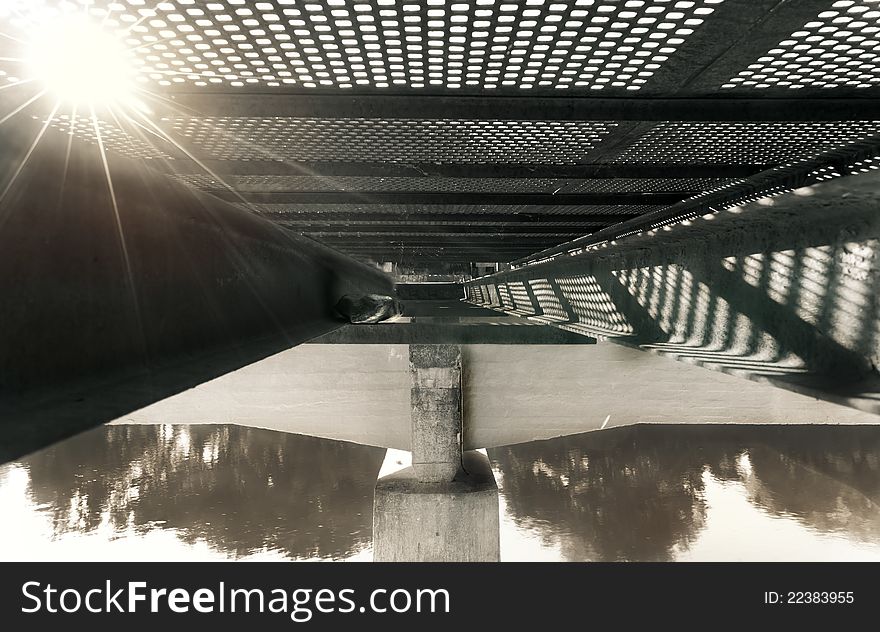 Metal structure of on old metal bridge, from beneath.