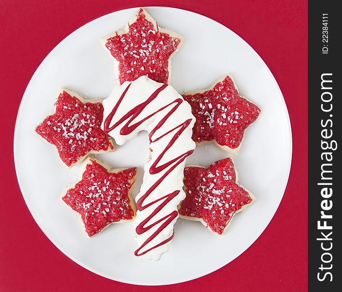 Plate of christmas cookies on red background. Plate of christmas cookies on red background