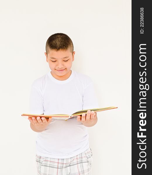 Asian boy reading book on white background