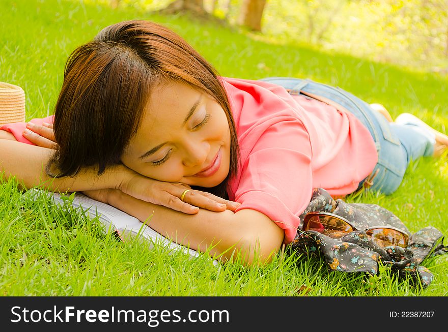 Thai Girl Sleeping On Grass In Park