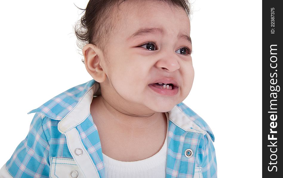 Adorable Indian baby crying a over white background