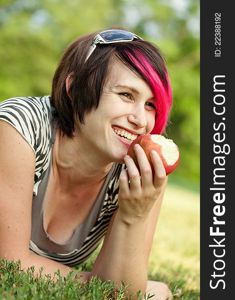 Young Punk Woman Eating An Apple