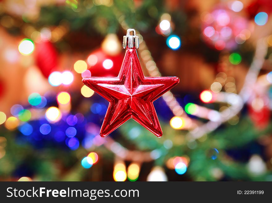 Red christmas star with decorated tree on background. Red christmas star with decorated tree on background