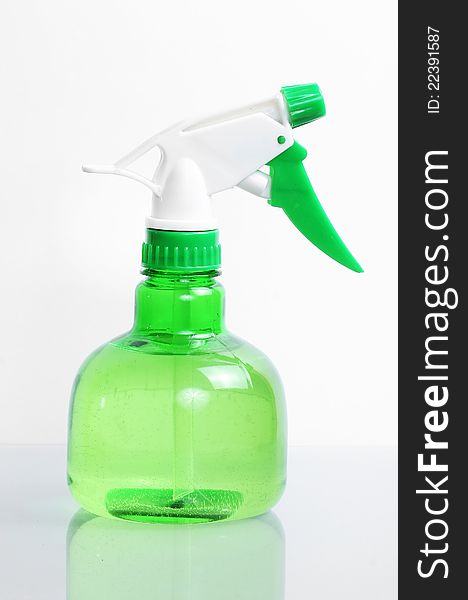 Green spay bottle detail filled with water