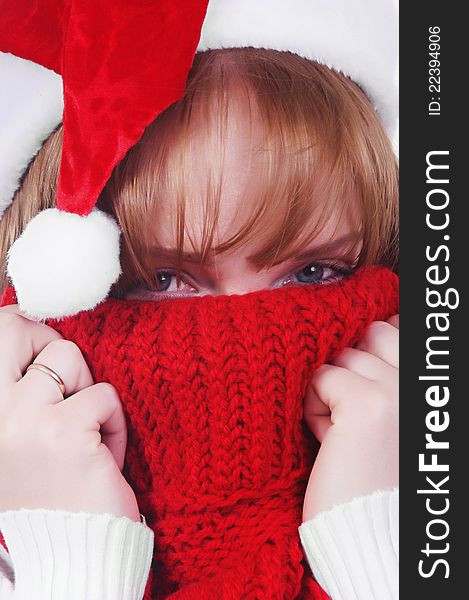 Girl with christmas hat and scarf over white. Girl with christmas hat and scarf over white