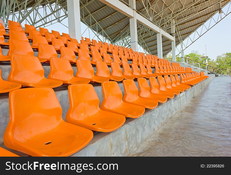 Sheer orange seats arranged in a row. Sheer orange seats arranged in a row.