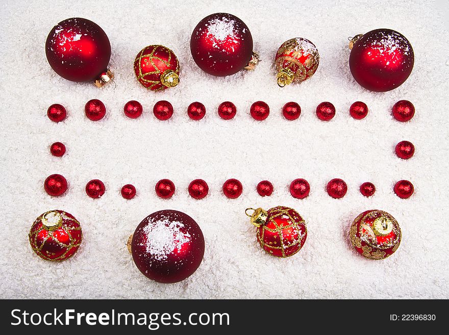 Christmas ornament frame made of white snow, red and gold ornaments