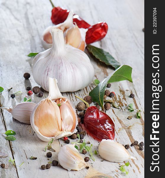 Garlic and peppers on a wooden table