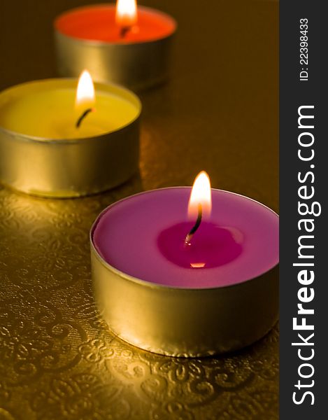 Three candles on a gold background