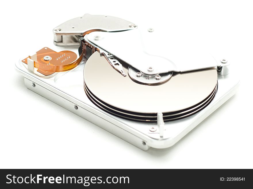Opened aluminium case of a hard disk drive with header and cylinders showing on white background.