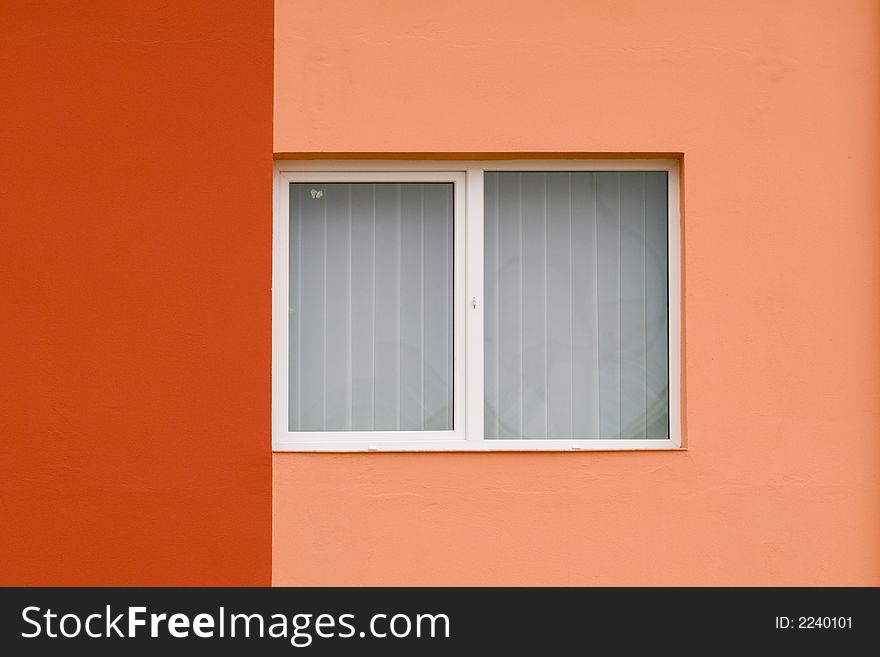 Colorful walll painted in warm colors with white window