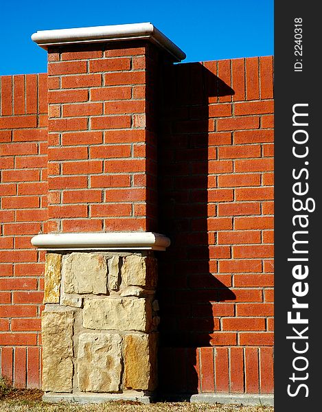 Column and wall made of bricks and stone. Column and wall made of bricks and stone