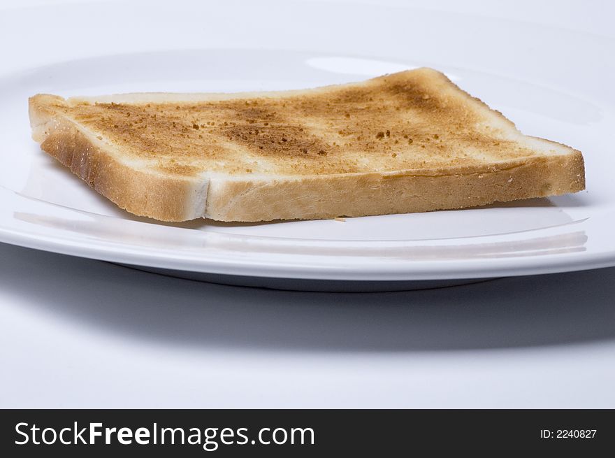 A piece of white toast on a white plate