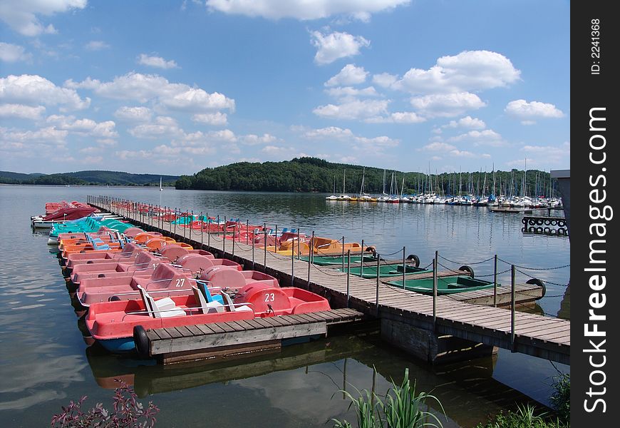 A view of the recreational boats and docks on the Botalsee in the Rheinland-Pfalz region of Germany.  The Botalsee is the largest lake in the region. A view of the recreational boats and docks on the Botalsee in the Rheinland-Pfalz region of Germany.  The Botalsee is the largest lake in the region.