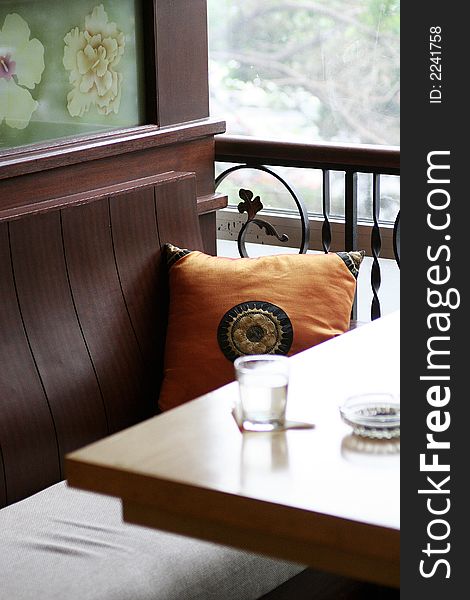 Glass and ashtray on table